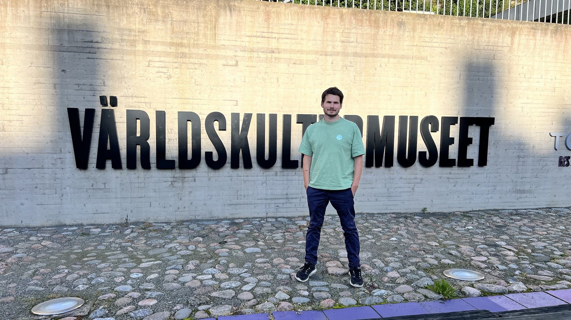 Dr. Jens M. Stober next to the Museum of World Culture sign outside in Gothenburg, Sweden